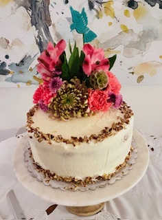 A round cake with pink dahlias