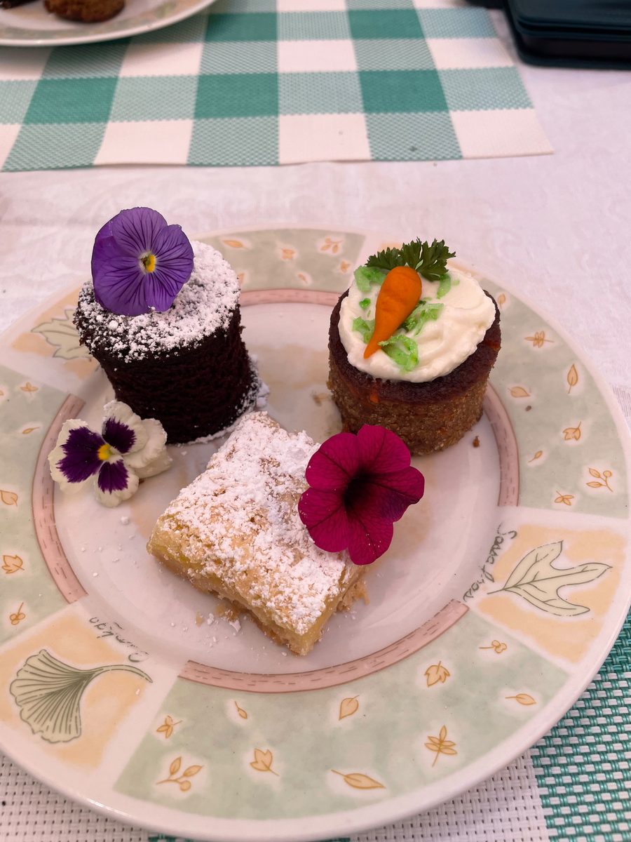 Dessert trio of a chocolate cake, mini carrot cake, and lemon bar with edible pansies — Patio Lunch at Sienne's Table