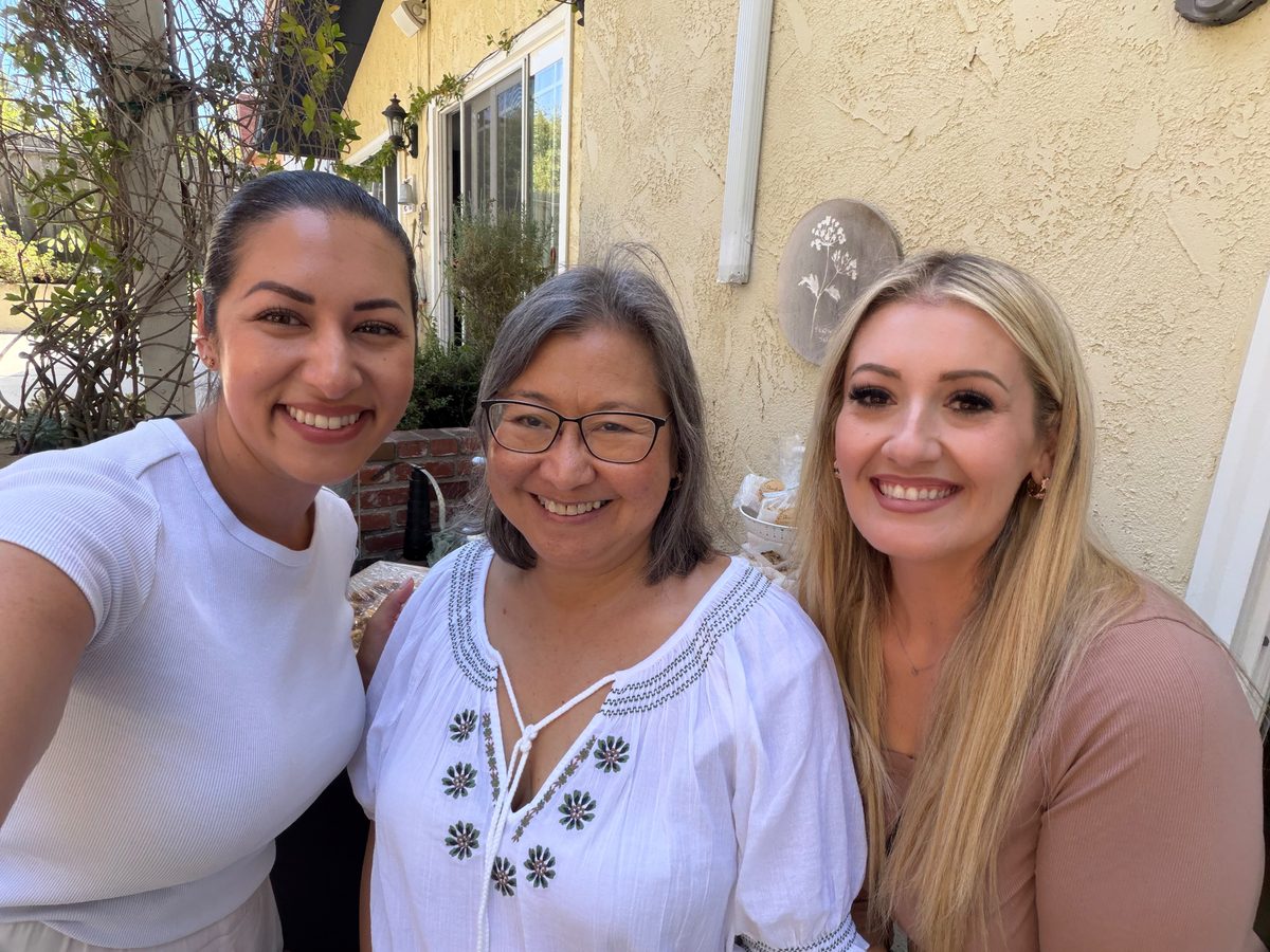 Sienne with two guests, smiling together at the Open House in Lomita, California