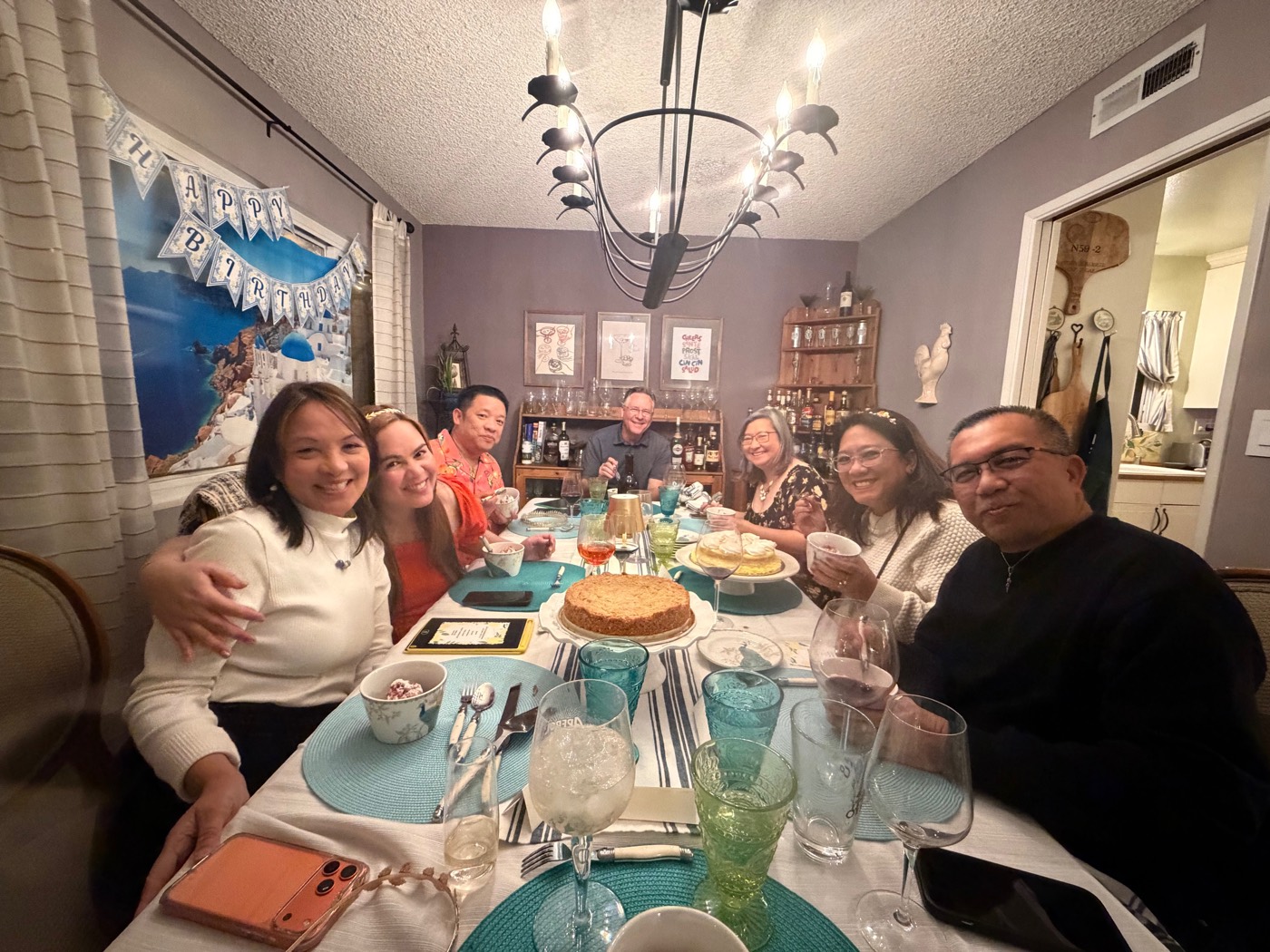 Friends gathered around a candlelit patio table